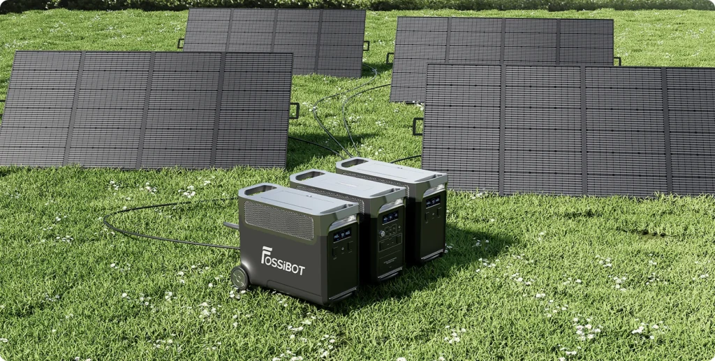 carga-solar-campo-fossibot-fb3840.jpg Estación FOSSiBOT F3600 Pro y dos baterías FB3840 cargándose en el césped con paneles solares plegables.